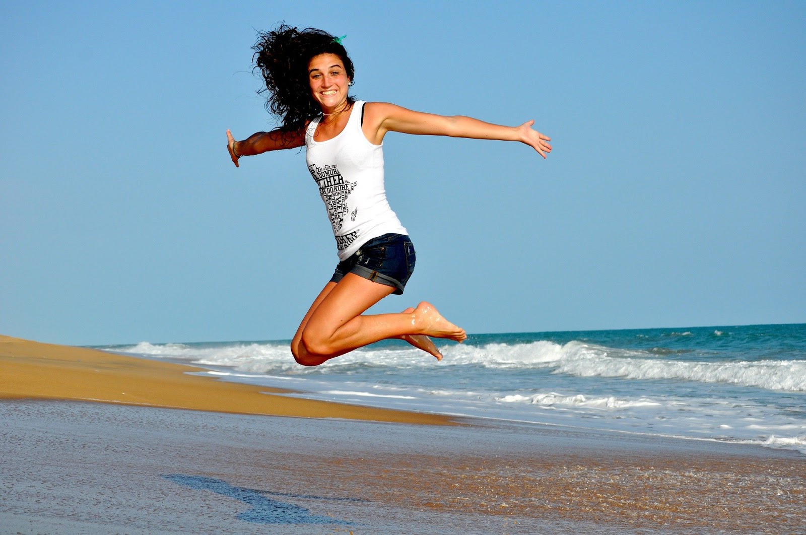 Woman jumping at the beach